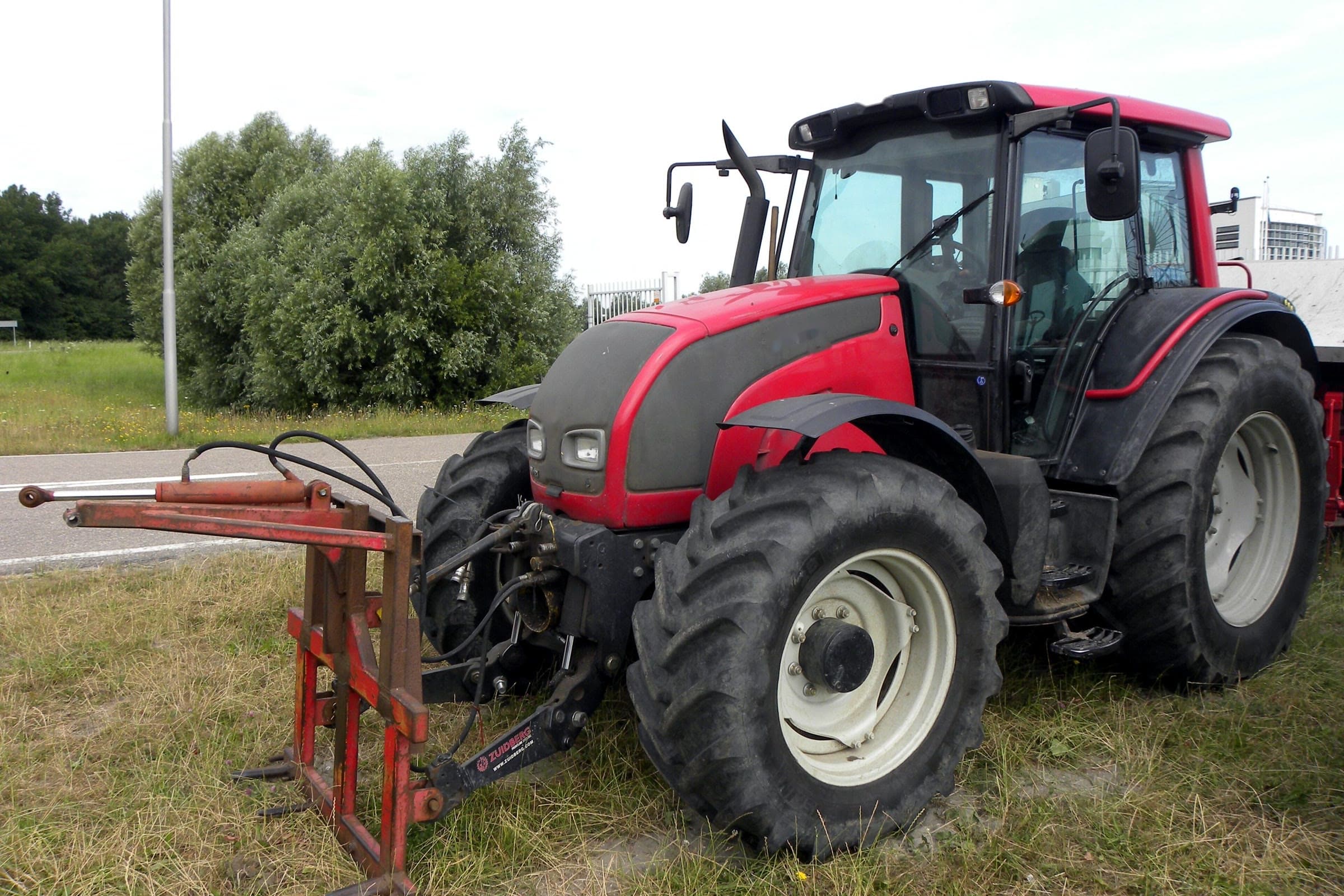 Rød Valtra N121 med frontløft, parkert i veikanten